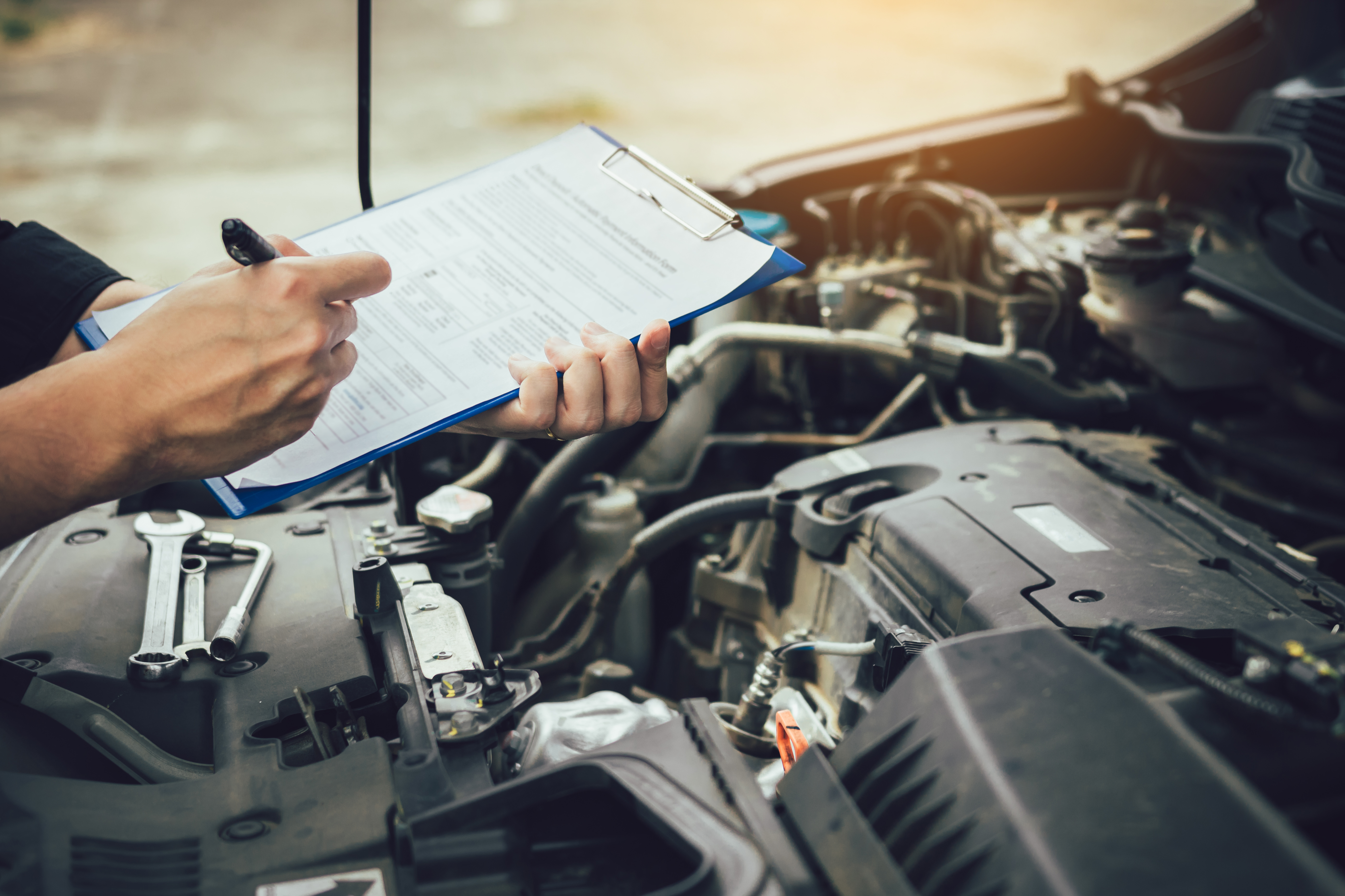 Car Mechanic Repairing Vehicle Engine And Listing Details